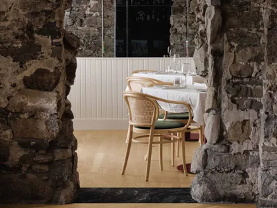 A modern restaurant interior featuring stone and concrete materials.