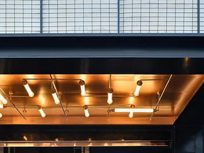 Modern entrance to a restaurant featuring metallic and glass materials.