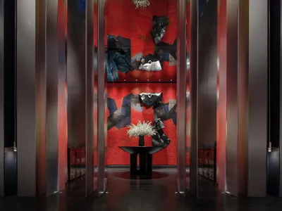 A modern hotel lobby featuring metallic texture floors and walls.