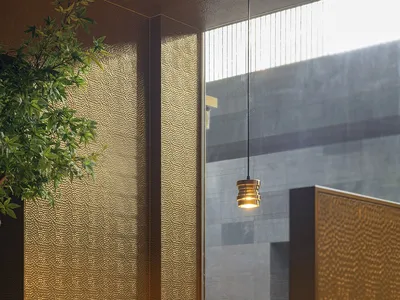 Modern restaurant interior with glass walls and hanging lamp