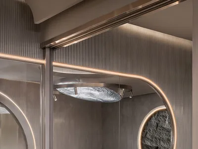 Modern, industrial-style restaurant showing a metallic window frame with circular glass panels.