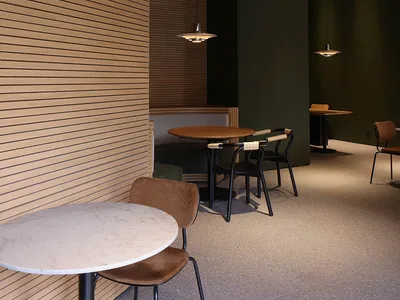 A modern restaurant interior featuring wooden walls and tables, minimalist furniture, and contemporary pendant lighting.