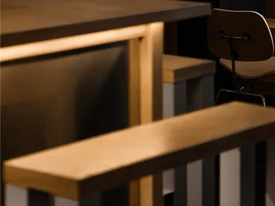 Industrial-style restaurant interior with wooden tables and chairs.