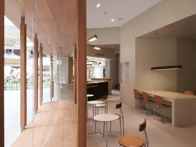 Modern restaurant interior with concrete and wooden elements.