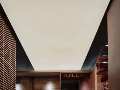 Modern hotel lobby featuring marble flooring and wooden paneling