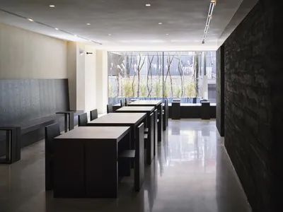 Sleek, modern restaurant interior with concrete floors and minimalist design.