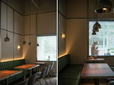 Industrial-style restaurant interior with metal tables and chairs.