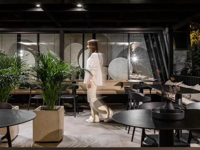 A modern cafe with concrete and glass materials.