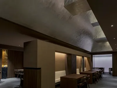 Contemporary restaurant interior with concrete and wood materials.