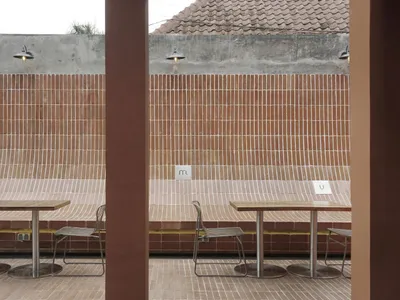 Outdoor seating area with brick walls and tables