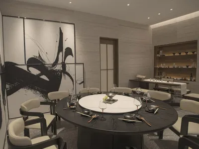 Modern dining room with black and white decor, featuring a round table, chairs, and abstract wall art.