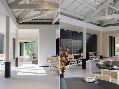 Modern interior design of a restaurant dining room with contemporary furniture and minimalist decor.