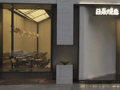 A modern minimalist restaurant exterior with sleek materials and clean lines.