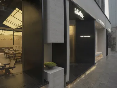 Modern restaurant interior featuring concrete, wood, and glass materials