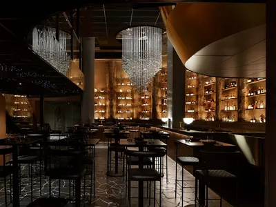 An industrial-style restaurant interior with metallic accents and modern lighting.