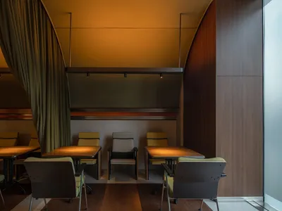 A modern industrial restaurant with wooden furniture and curtain lighting