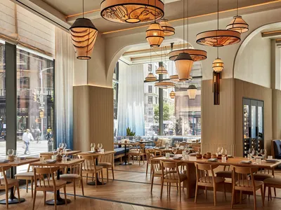 Industrial-themed restaurant interior with wooden tables and chairs.