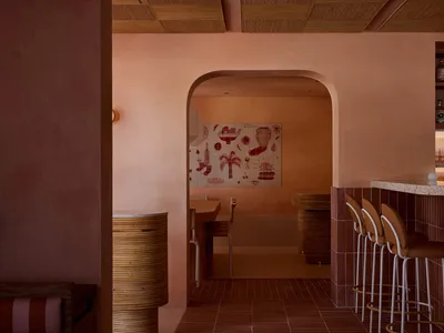 A modern restaurant interior with terrazzo tiles on the floor and walls.