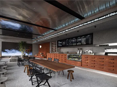 A modern restaurant interior with metallic ceiling, concrete walls, and wooden furniture.