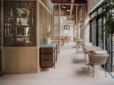 A modern restaurant interior featuring wood, stone, glass, and metal materials