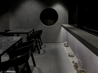 現代工業風餐廳，搭配混凝土牆面與餐桌。