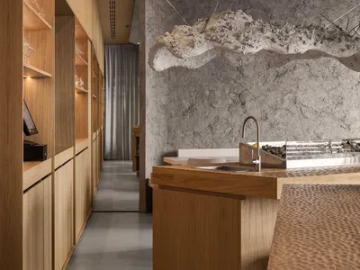 An industrial-themed restaurant interior featuring a concrete wall and wooden counter.
