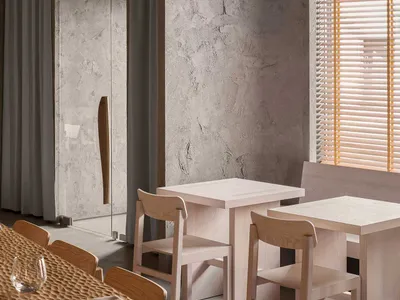 Industrial restaurant interior with concrete walls, wooden tables, and chairs