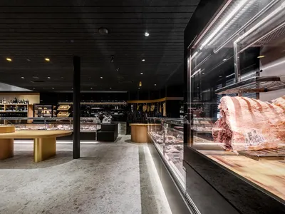 Modern restaurant interior featuring a wooden floor and counter.