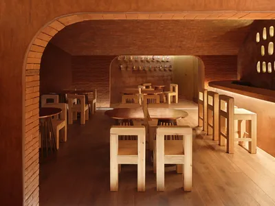 A modern restaurant bar interior with wooden furniture and a cozy atmosphere.