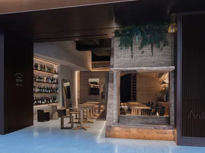 A modern restaurant interior featuring wood accents and minimalist design