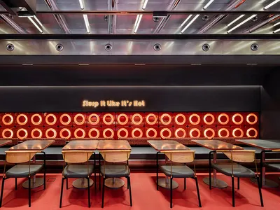 A spacious restaurant interior featuring a metallic inlay design
