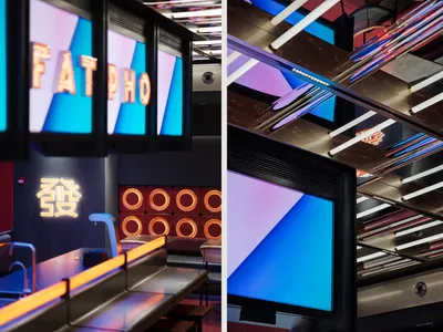 A vibrant and modern restaurant interior with colorful neon signs.