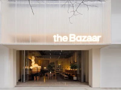 Modern restaurant interior with glass paneling and concrete flooring