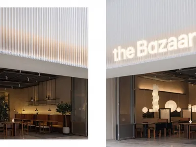 A modern restaurant interior with warm lighting and minimalist design.