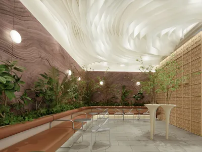 Modern restaurant interior with wooden walls, concrete flooring, and greenery