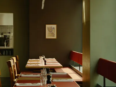 A modern restaurant interior with wooden tables and chairs