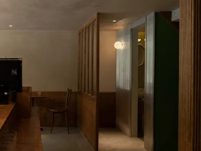 Industrial-style restaurant bar with metal walls and decor.