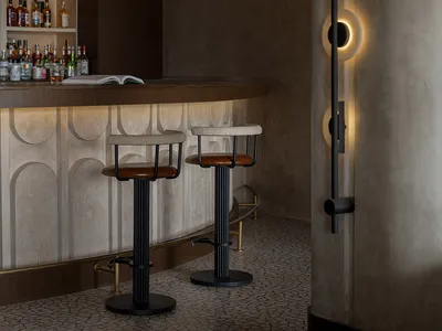 Modern bar area featuring a concrete counter with a metal railing and wooden bar stools.
