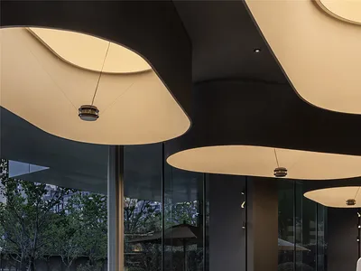 Modern hotel lobby with large glass walls and contemporary furniture.