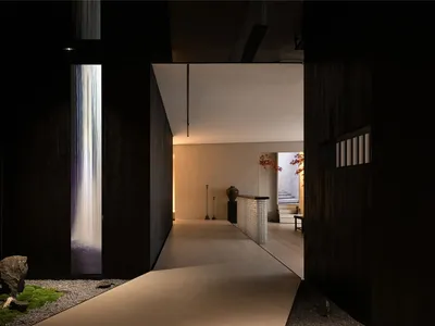 Modern minimalist hotel corridor with wooden floors and minimalist design elements.