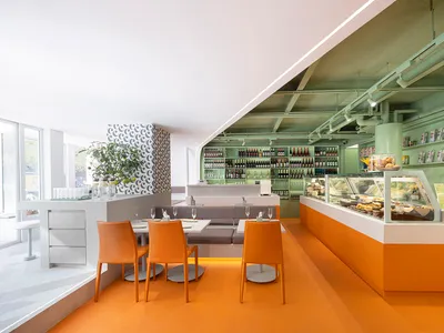 An open-concept restaurant featuring modern design elements such as metal, wood, and glass.