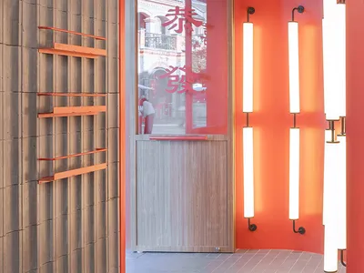 An orange and wood interior design of a modern restaurant.