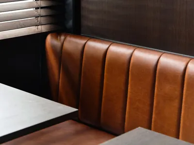 Modern, contemporary leather booth seating in a restaurant interior design setting.