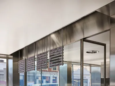 A sleek, modern restaurant counter featuring steel and glass elements