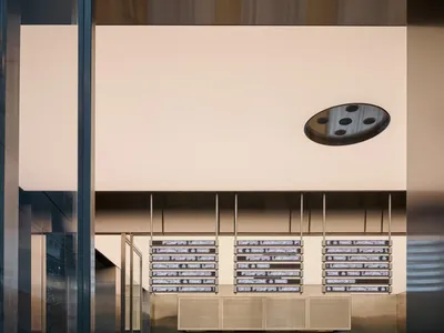A modern restaurant with a metallic counter and glass display case.
