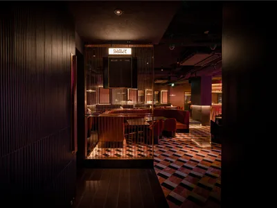 Industrial-style restaurant interior with metal ceiling and modern seating areas