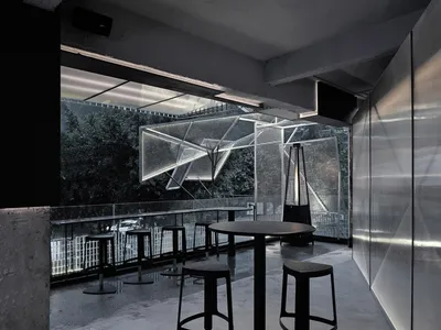 Indoor restaurant with metallic seating and tables, industrial design elements