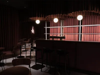 A photograph of a modern restaurant interior with fabric curtains.