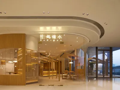 Modern restaurant entry featuring a large floating wooden sign.