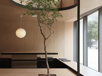 Modern restaurant interior designed with wood flooring and minimalist decor.